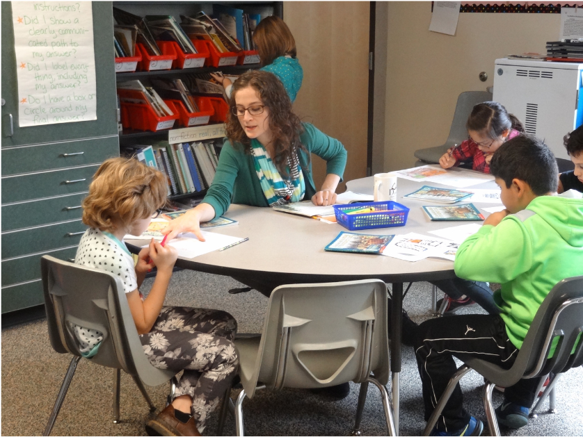 A teacher reading to elementary students in a classroom